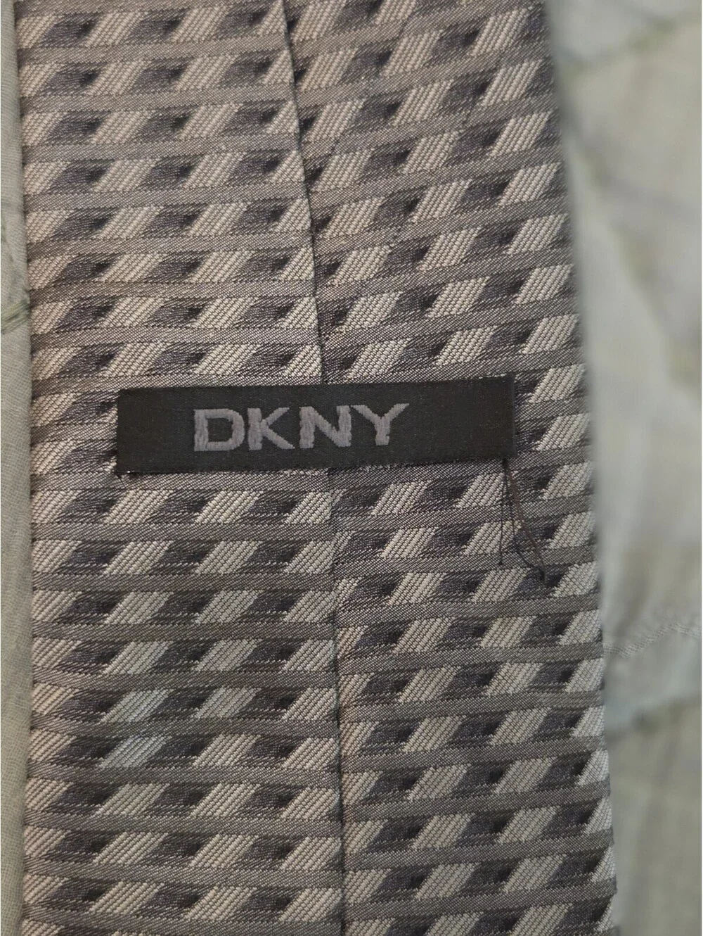 DKNY Men's Tie with distinctive geometric pattern in shades of Gray and Black.